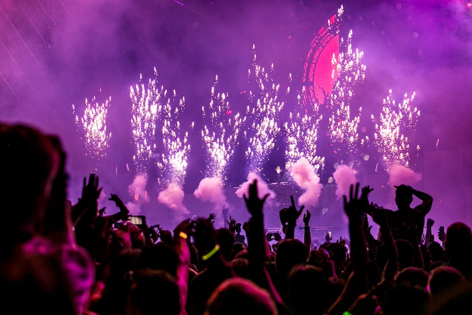 Vibrant EDM concert scene with fireworks, smoke, and enthusiastic crowd enjoying the music