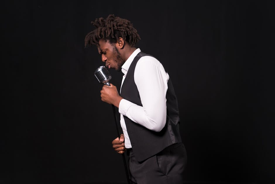 African American man passionately singing into a vintage microphone